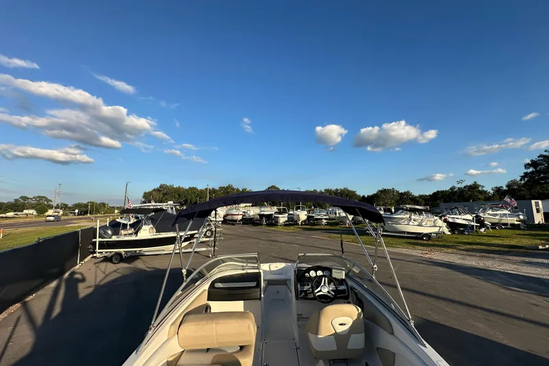 Slide: The Image of 2017 Regal 1900 Bowrider boat parked in a marina under a clear blue sky. - 14