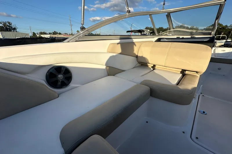 Slide: The Image of 2017 Regal 1900 Bowrider interior with beige seating and speaker, under clear blue sky. - 21
