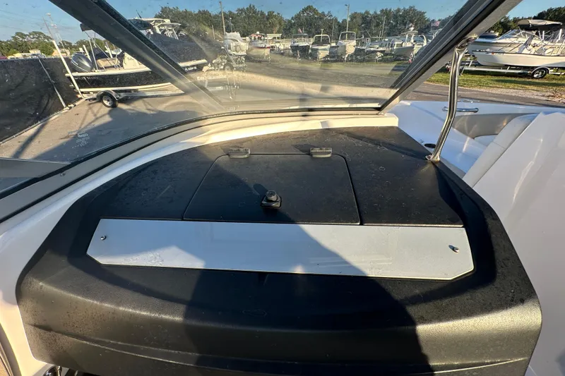 Slide: The Image of 2017 Regal 1900 Bowrider dashboard view with windshield and outdoor boat display. - 23