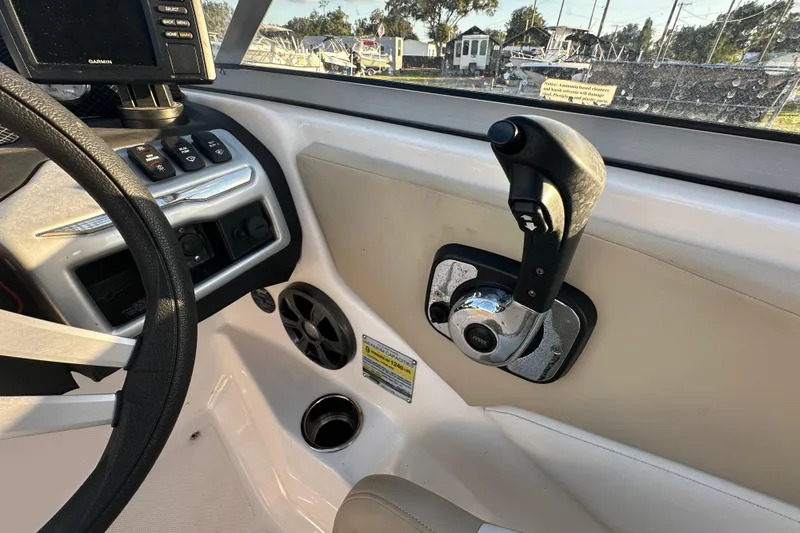 Slide: The Image of 2017 Regal 1900 Bowrider boat dashboard with steering wheel and control panel. - 34