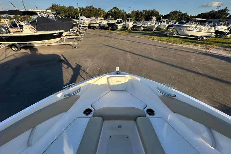 Slide: The Image of 2017 Regal 1900 Bowrider boat in a marina, surrounded by various other boats. - 37