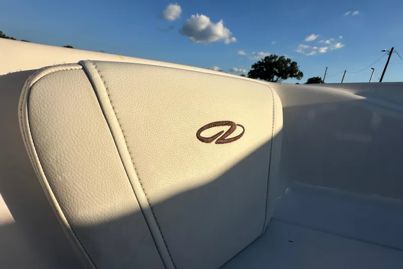 Slide: The Image of 2017 Regal 1900 Bowrider boat seat with logo, under clear blue sky. - 40