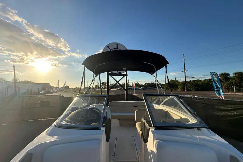 Slide: The Image of 2017 Regal 1900 Bowrider boat with canopy at sunset, parked outdoors. - 41