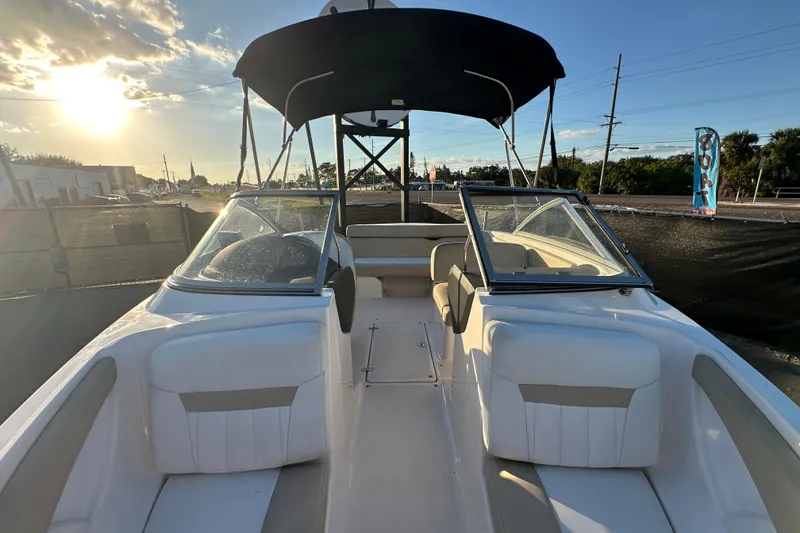 Slide: The Image of 2017 Regal 1900 Bowrider boat with seating, under a sunny sky. - 42