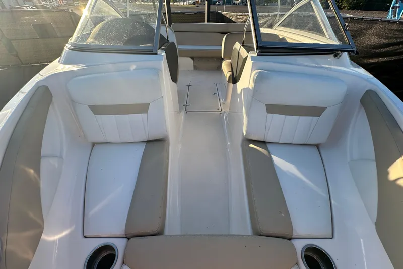 Slide: The Image of 2017 Regal 1900 Bowrider interior with white and beige seating, cup holders, and windshield. - 43
