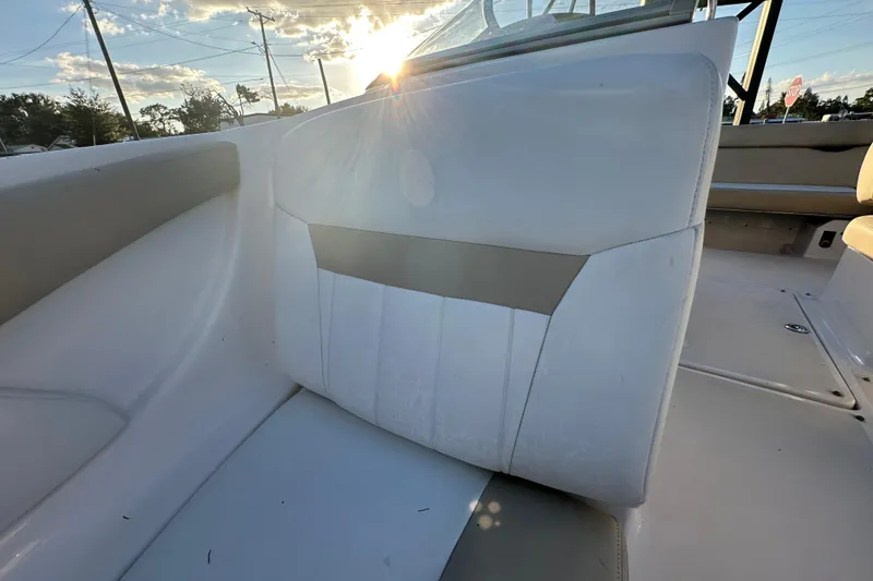Slide: The Image of 2017 Regal 1900 Bowrider boat interior with white seating and sunlight. - 45