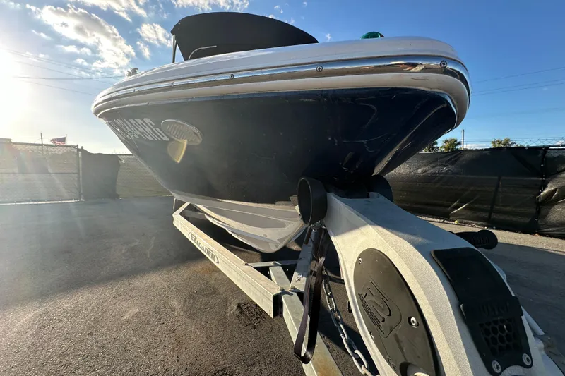Slide: The Image of 2017 Regal 1900 Bowrider boat on trailer under clear blue sky. - 5