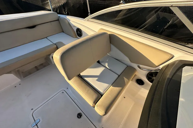 Slide: The Image of 2017 Regal 1900 Bowrider interior with beige seating and cup holders. - 57