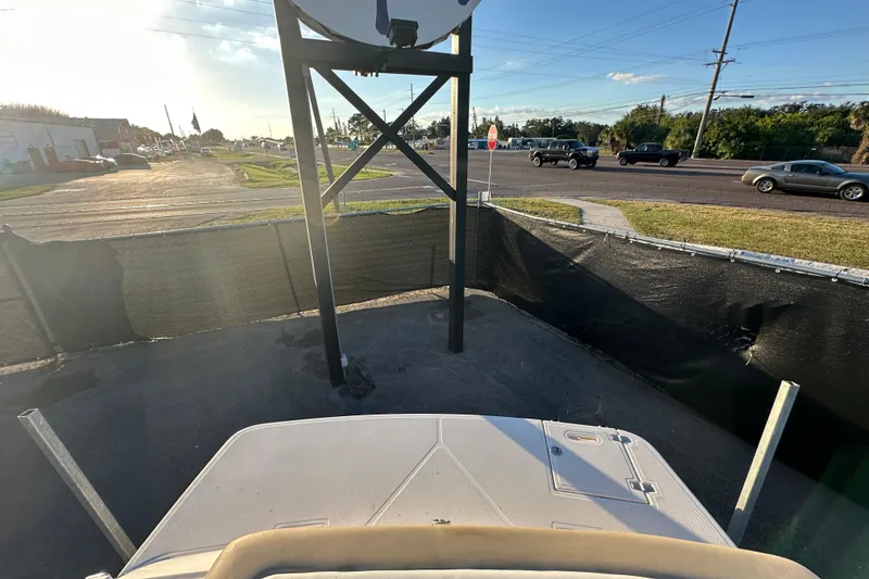 Slide: The Image of 2017 Regal 1900 Bowrider parked near a road with passing vehicles. - 64