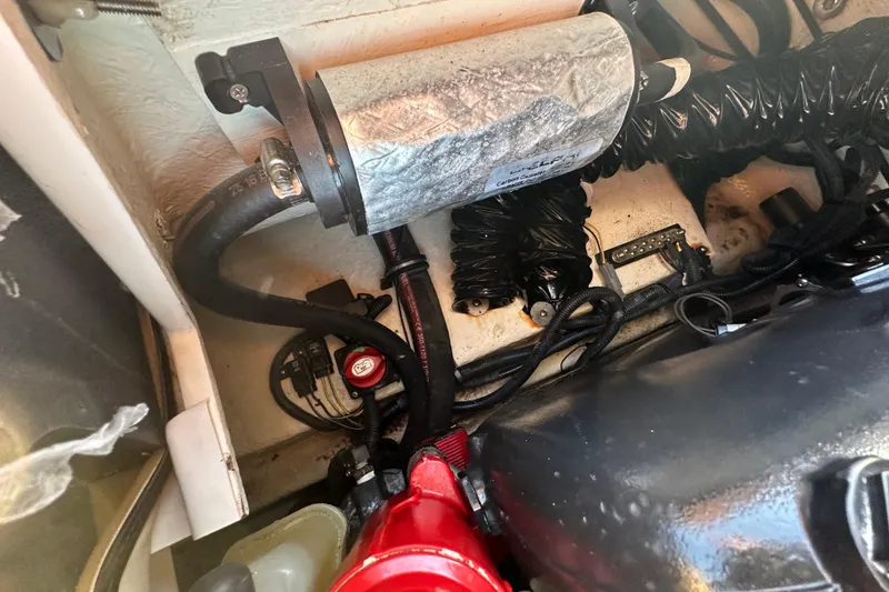 Slide: The Image of Engine compartment of a 2017 Regal 1900 Bowrider boat, showing hoses and components. - 68