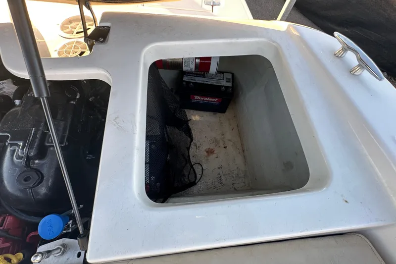Slide: The Image of 2017 Regal 1900 Bowrider engine compartment with battery and fire extinguisher. - 69
