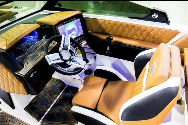 Slide: The Image of 2025 Tigé 22RZX boat interior with luxurious leather seating and advanced dashboard controls. - 11