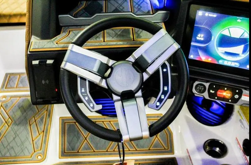 Slide: The Image of Steering wheel and dashboard of 2025 Tigé 22RZX boat with touchscreen display. - 13