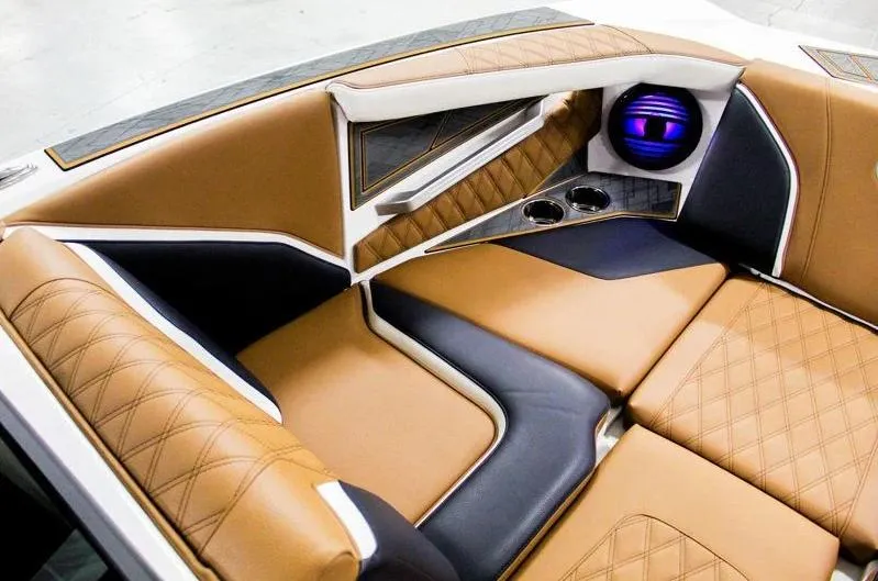 Slide: The Image of Luxurious interior of 2025 Tigé 22RZX boat with tan and navy seating. - 16