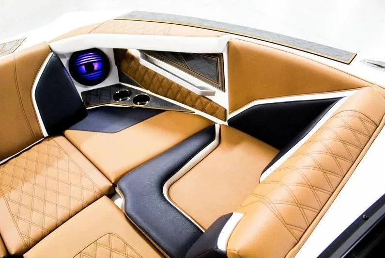 Slide: The Image of Luxurious interior of 2025 Tigé 22RZX boat with tan and black seating. - 17