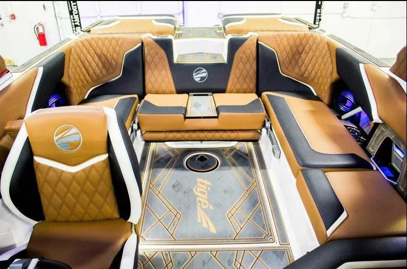 Slide: The Image of Luxurious interior of 2025 Tigé 22RZX boat with brown leather seating and modern design. - 18