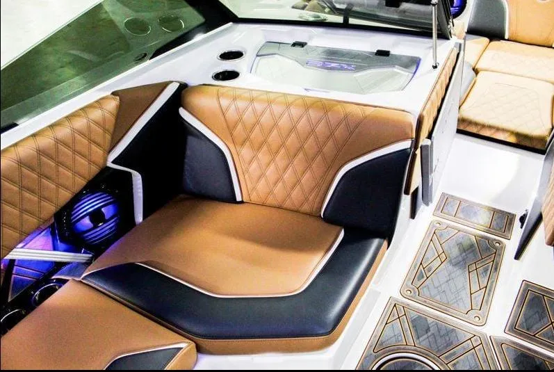 Slide: The Image of 2025 Tigé 22RZX boat interior with luxurious brown and black seating, modern design. - 19