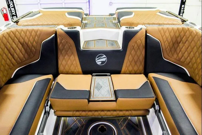 Slide: The Image of 2025 Tigé 22RZX boat interior with luxurious brown and black diamond-stitched seating. - 21