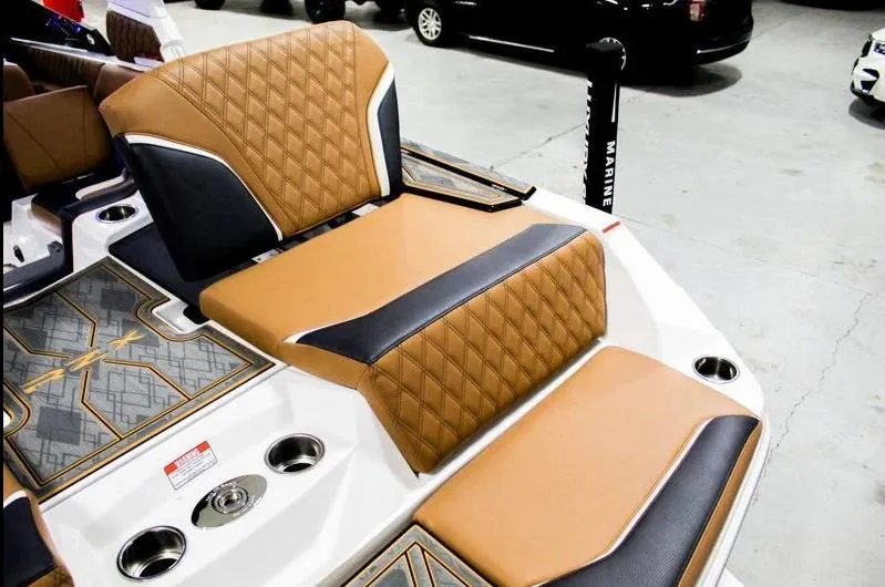 Slide: The Image of 2025 Tigé 22RZX boat interior with tan and black diamond-stitched seating. - 26