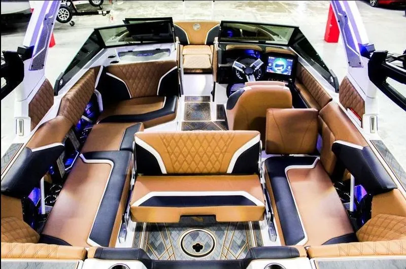 Slide: The Image of Luxurious interior of 2025 Tigé 22RZX boat with brown and black seating. - 27