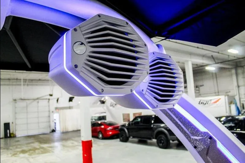 Slide: The Image of 2025 Tigé 22RZX boat speakers with LED lighting in a showroom. - 31