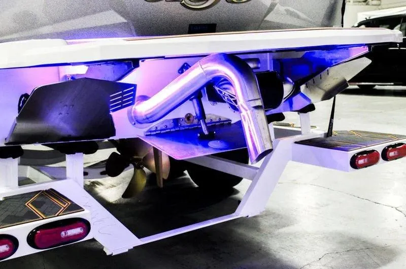 Slide: The Image of 2025 Tigé 22RZX boat rear view with illuminated exhaust and propeller. - 36