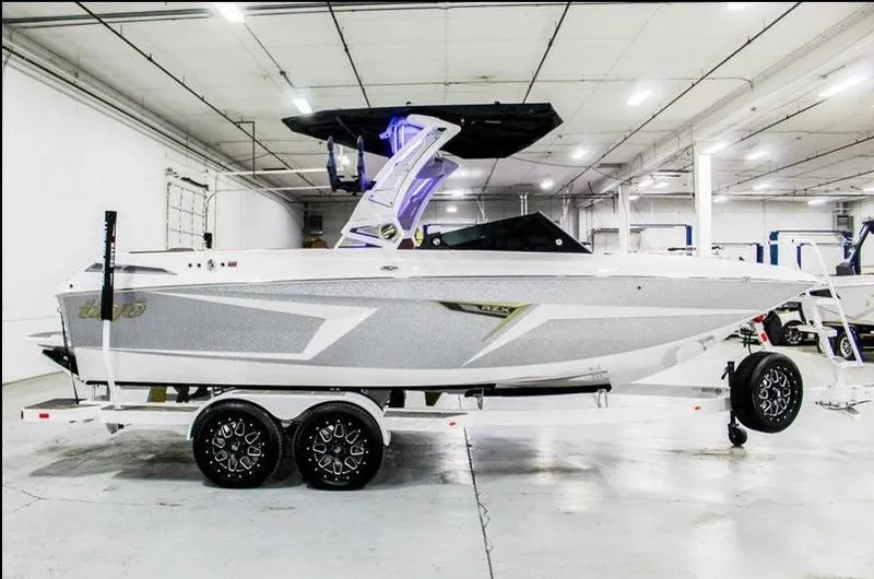 Slide: The Image of 2025 Tigé 22RZX boat in a showroom, featuring sleek design and modern aesthetics. - 4