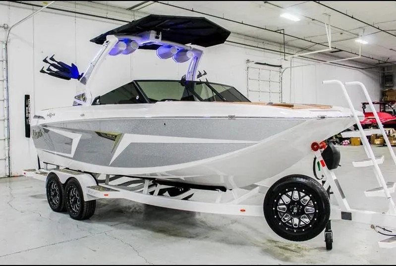 Slide: The Image of 2025 Tigé 22RZX boat in a showroom, featuring sleek design and modern amenities. - 5
