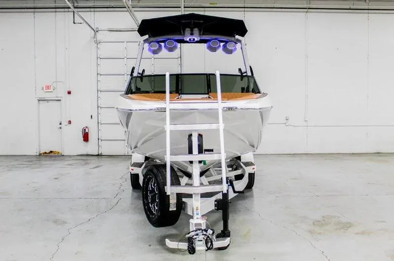 Slide: The Image of 2025 Tigé 22RZX boat on trailer in warehouse setting. - 7