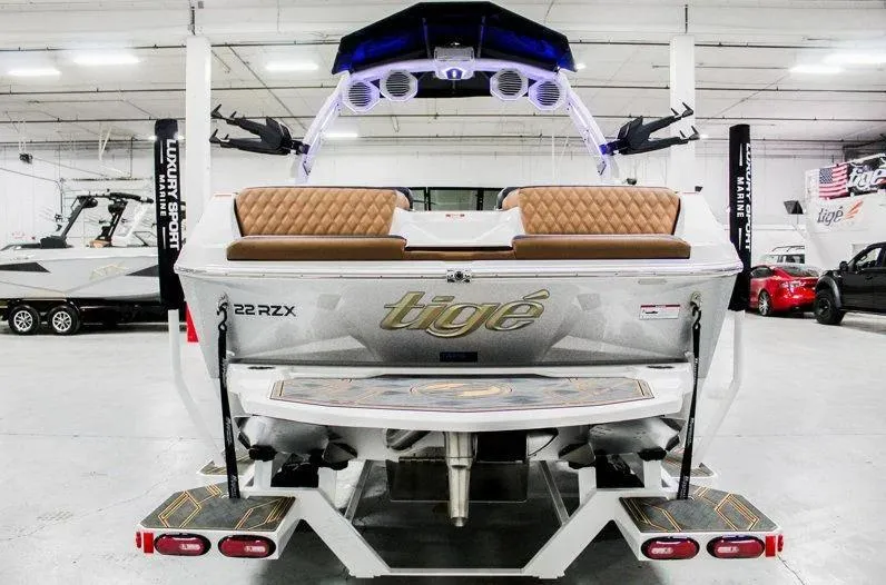 Slide: The Image of 2025 Tigé 22RZX boat in showroom, featuring sleek design and premium seating. - 8