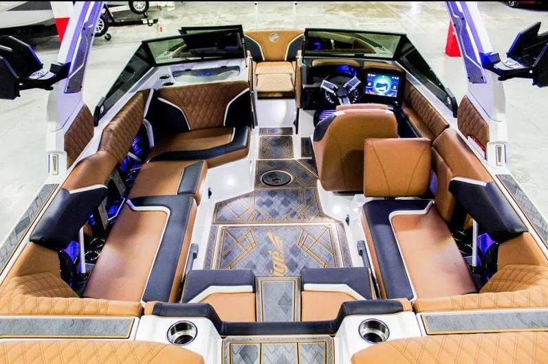 Slide: The Image of Luxurious interior of 2025 Tigé 22RZX boat with brown leather seating and modern dashboard. - 9