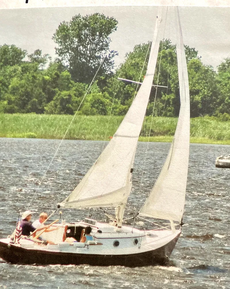 Slide: The Image of Sailboat on a lake, Great Harbour 26 ft., 2000 model, with lush green trees in the background. - 18