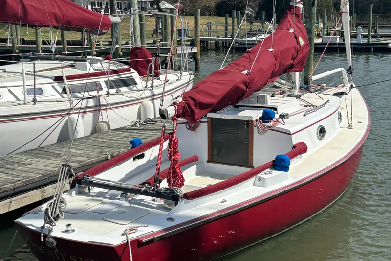 Slide: The Image of Red Great Harbour 26 ft. sailboat docked, 2000 model, with maroon sails and white deck. - 19