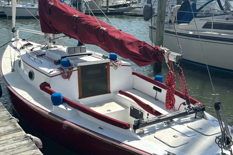 Slide: The Image of Red and white 2000 Great Harbour 26 ft. sailboat docked at marina. - 20