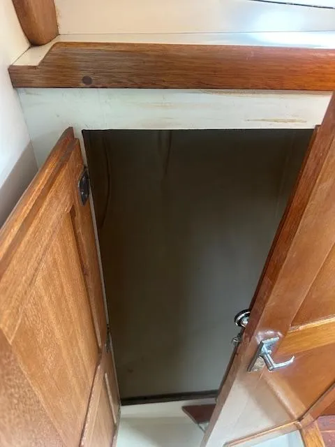 Slide: The Image of Wooden interior door on a 1979 Bristol 299 boat, partially open. - 11