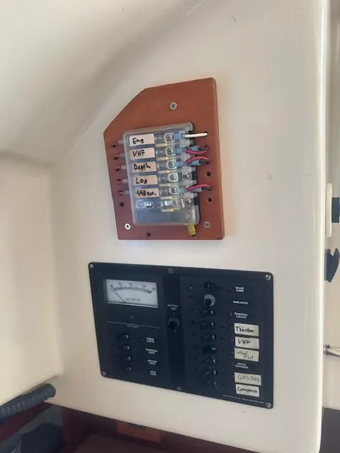 Slide: The Image of Electrical panel on a 1979 Bristol 299 boat, featuring labeled switches and a meter. - 13