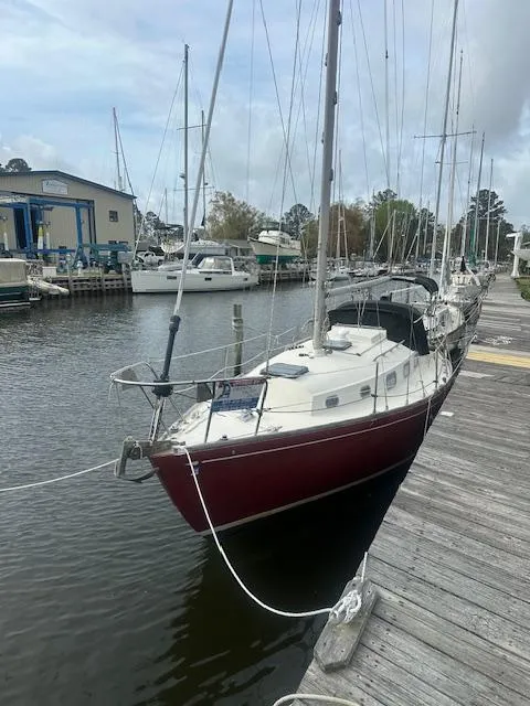 Slide: The Image of 1979 Bristol 299 sailboat docked at a marina, surrounded by other boats. - 2