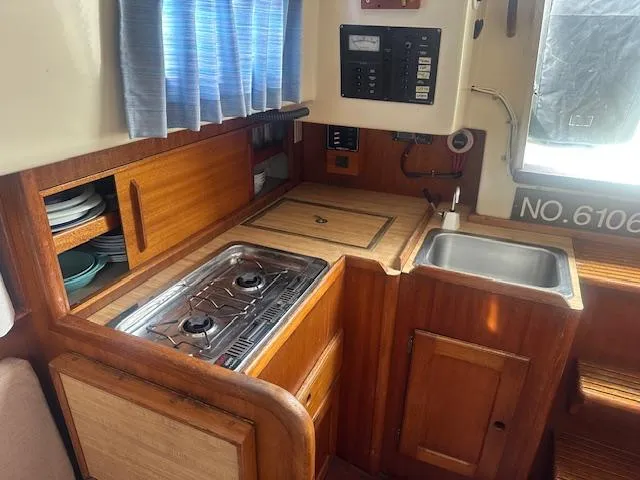 Slide: The Image of 1979 Bristol 299 yacht kitchen with stove, sink, and wooden cabinetry. - 4