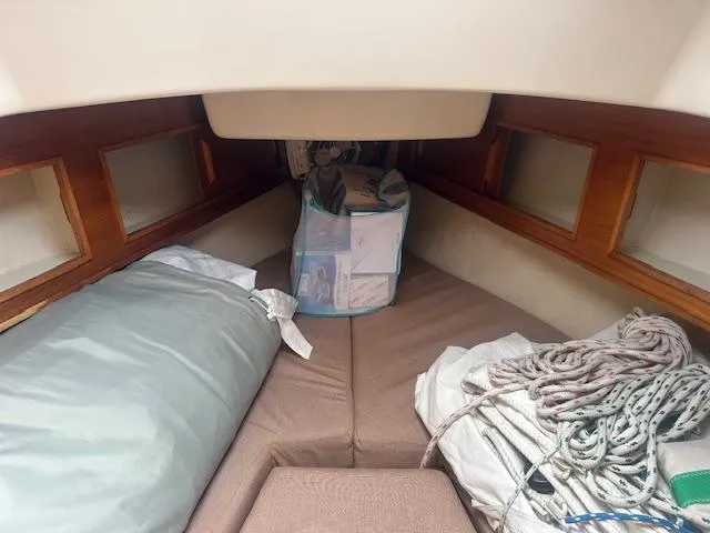 Slide: The Image of Interior cabin of a 1979 Bristol 299 sailboat with cushions and ropes. - 9