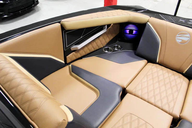 Slide: The Image of Luxurious interior of 2025 Tigé 22RZX boat with tan and black seating. - 10