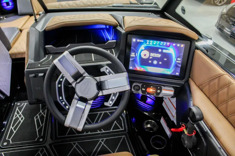 Slide: The Image of 2025 Tigé 22RZX boat dashboard with modern steering wheel and touchscreen display. - 13