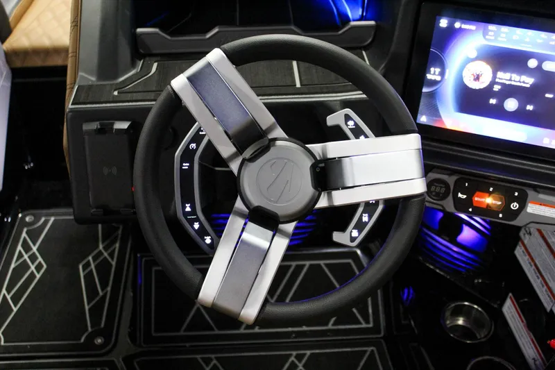 Slide: The Image of 2025 Tigé 22RZX boat dashboard with modern steering wheel and digital display. - 15