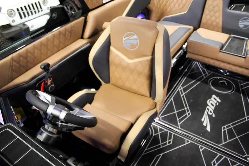 Slide: The Image of 2025 Tigé 22RZX boat interior with luxurious seating and modern steering wheel design. - 16
