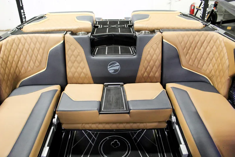 Slide: The Image of Luxurious interior of 2025 Tigé 22RZX boat with tan and black seating. - 19