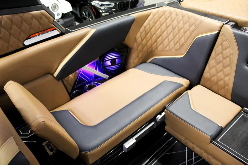 Slide: The Image of 2025 Tigé 22RZX interior with luxurious tan and black seating, diamond stitching, and illuminated speaker. - 20