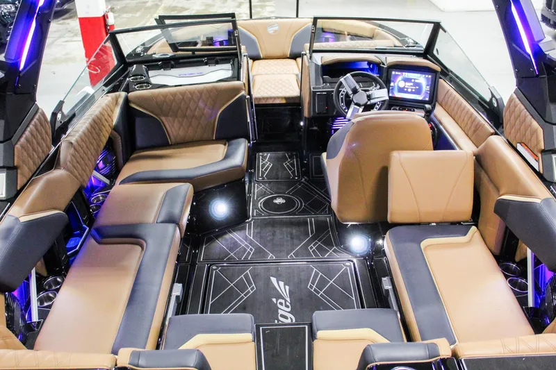 Slide: The Image of Luxurious interior of 2025 Tigé 22RZX boat with modern seating and advanced dashboard. - 23