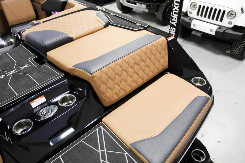Slide: The Image of 2025 Tigé 22RZX boat interior with tan and black diamond-stitched seating. - 24