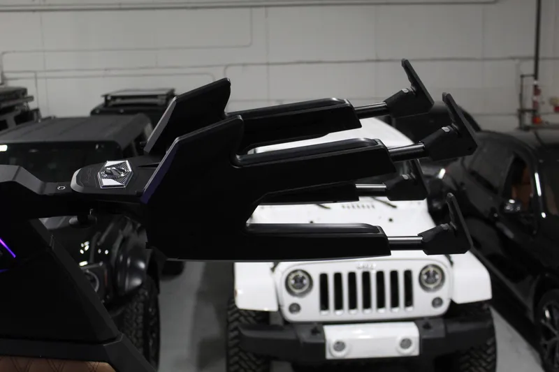 Slide: The Image of 2025 Tigé 22RZX boat accessory in a garage with parked vehicles. - 28