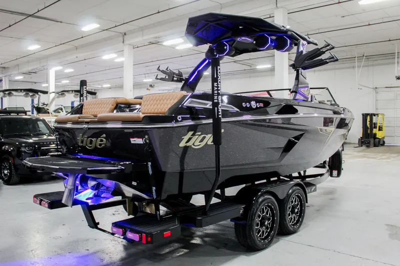 Slide: The Image of 2025 Tigé 22RZX boat in showroom, featuring sleek design and modern amenities. - 4
