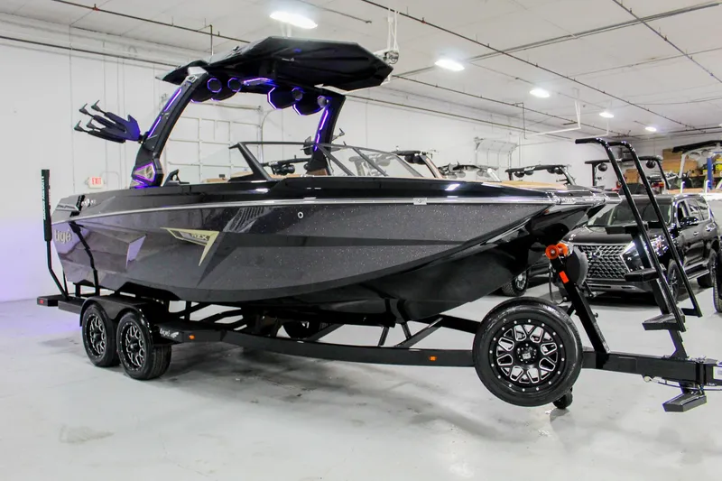 Slide: The Image of 2025 Tigé 22RZX boat on trailer in indoor showroom. - 6